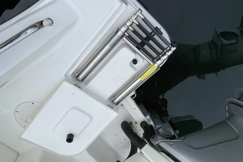 Slide: The Image of 2023 Boston Whaler 240 Vantage boat ladder and deck detail by the water. - 38