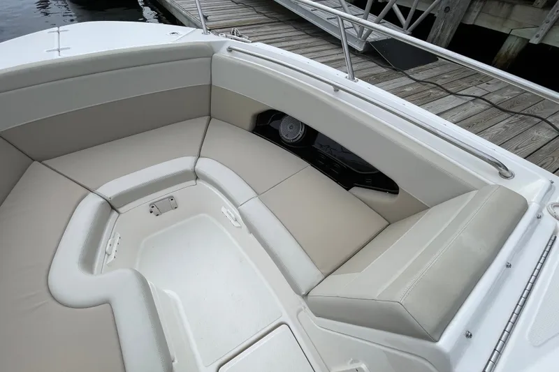 Slide: The Image of 2023 Boston Whaler 240 Vantage boat interior with cushioned seating and speaker system. - 64