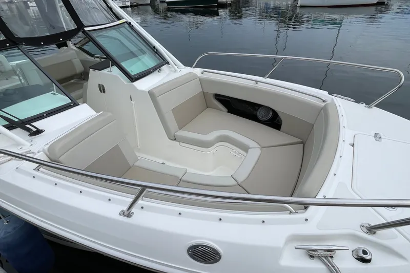 Slide: The Image of 2023 Boston Whaler 240 Vantage boat interior with cushioned seating and sleek design. - 12