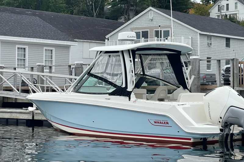 Slide: The Image of 2023 Boston Whaler 240 Vantage boat docked at marina, side view. - 30