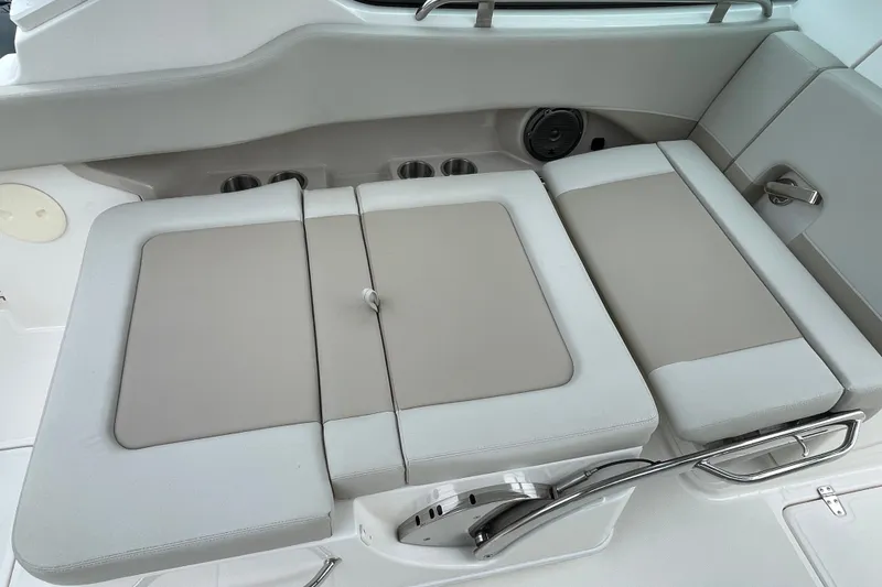 Slide: The Image of 2023 Boston Whaler 240 Vantage boat seating area with cushioned seats and cup holders. - 44