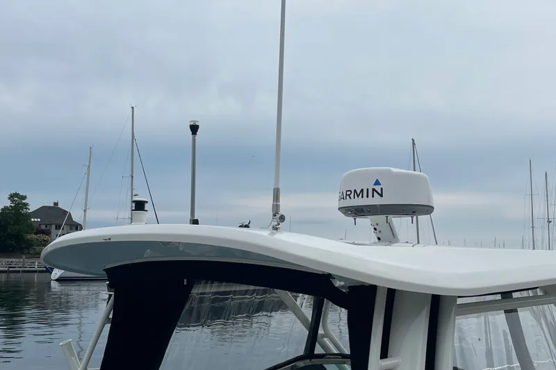 Slide: The Image of 2023 Boston Whaler 240 Vantage with Garmin radar, docked in a marina. - 19