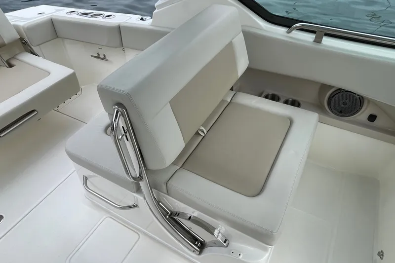 Slide: The Image of 2023 Boston Whaler 240 Vantage boat interior seating with cup holders and speaker. - 47