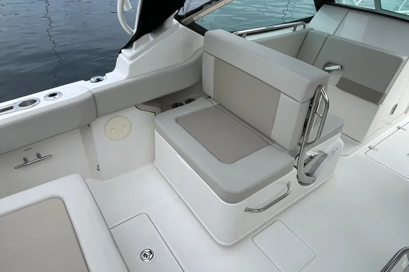 Slide: The Image of 2023 Boston Whaler 240 Vantage boat interior with cushioned seating and stainless steel accents. - 40