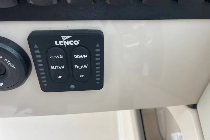 Slide: The Image of Lenco trim tab controls on 2023 Boston Whaler 240 Vantage boat dashboard. - 57
