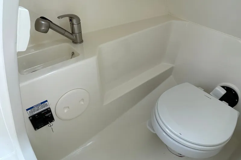 Slide: The Image of 2023 Boston Whaler 240 Vantage boat bathroom with sink and toilet. - 51