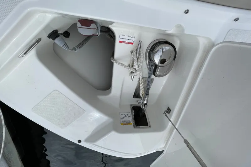 Slide: The Image of Anchor compartment of 2023 Boston Whaler 240 Vantage boat, featuring rope and winch. - 67
