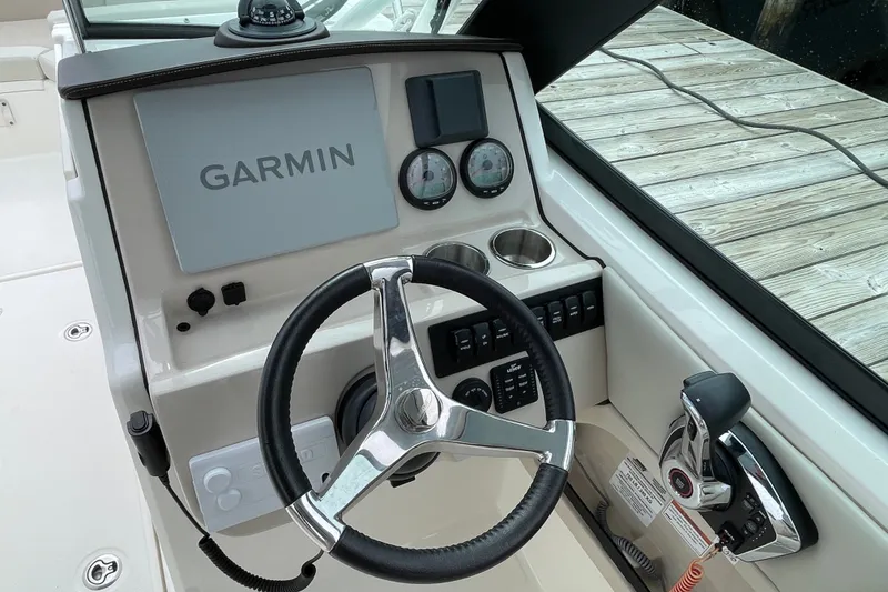 Slide: The Image of 2023 Boston Whaler 240 Vantage helm with Garmin display and steering wheel. - 52