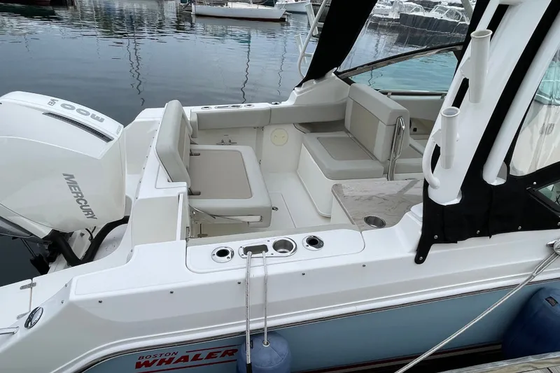 Slide: The Image of 2023 Boston Whaler 240 Vantage boat interior with seating and Mercury engine. - 18