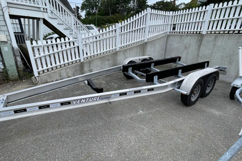 Slide: The Image of Trailer for 2023 Boston Whaler 240 Vantage, parked on concrete near white fence. - 85