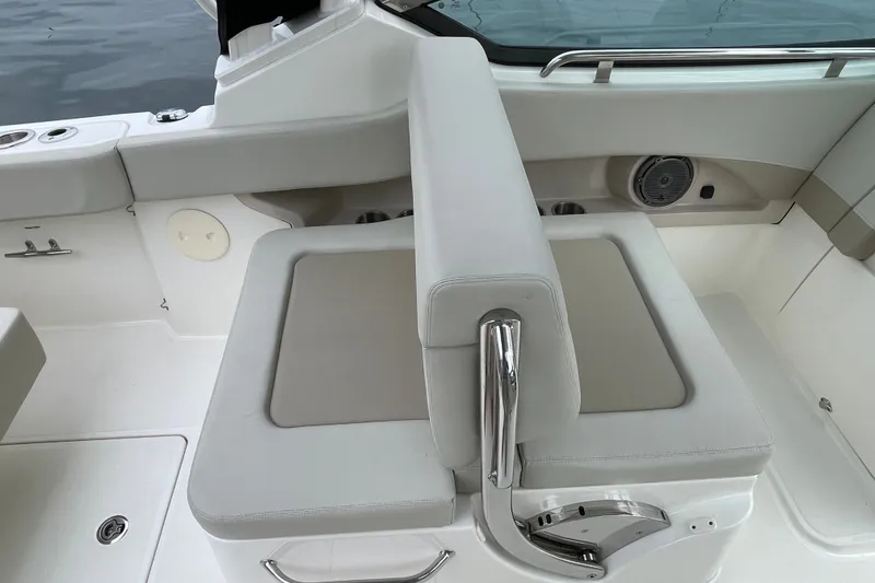 Slide: The Image of 2023 Boston Whaler 240 Vantage boat interior with cushioned seating and stainless steel accents. - 43