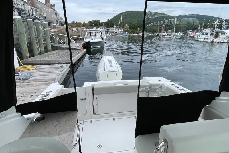 Slide: The Image of 2023 Boston Whaler 240 Vantage docked at a scenic marina with surrounding boats. - 79