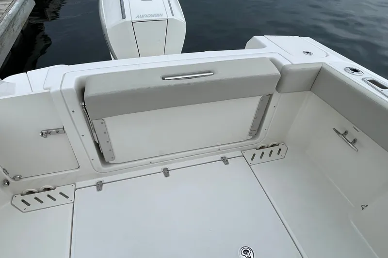 Slide: The Image of 2023 Boston Whaler 240 Vantage boat interior with Mercury engine, docked on calm water. - 72