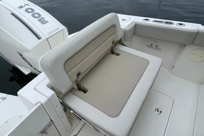 Slide: The Image of 2023 Boston Whaler 240 Vantage boat with Mercury engine and cushioned seating. - 39