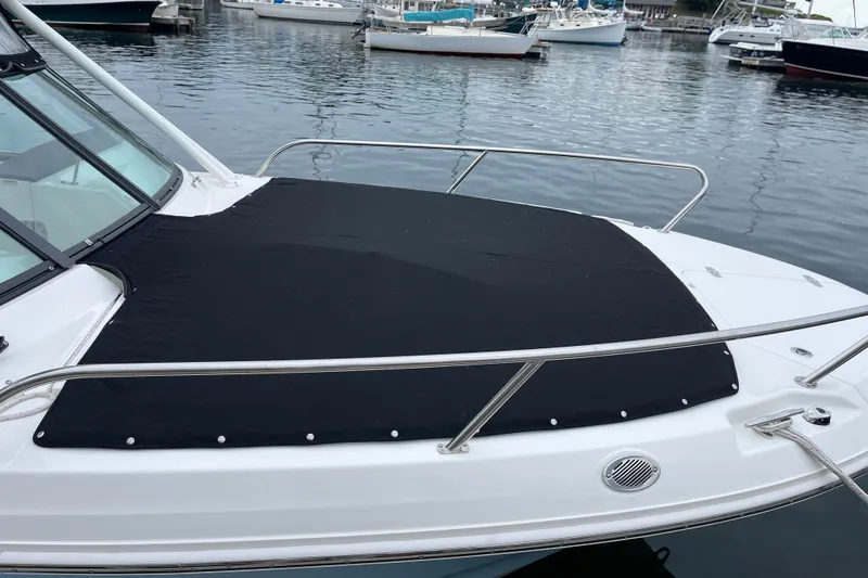 Slide: The Image of 2023 Boston Whaler 240 Vantage boat with black cover docked in marina. - 80