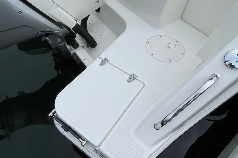 Slide: The Image of 2023 Boston Whaler 240 Vantage boat deck with storage compartment and railing. - 37