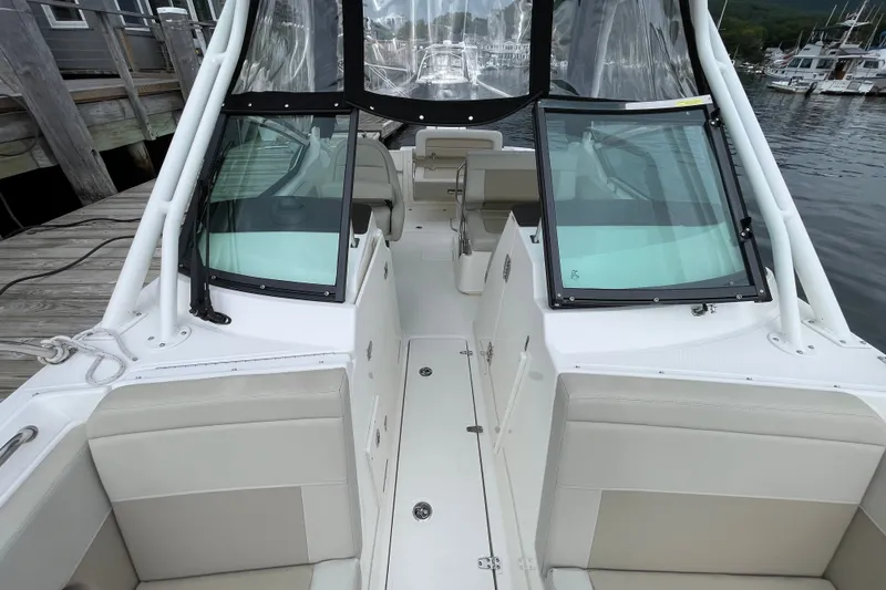 Slide: The Image of 2023 Boston Whaler 240 Vantage boat interior, docked at marina with clear windshield. - 69