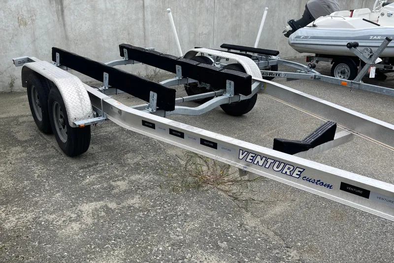 Slide: The Image of Boat trailer for 2023 Boston Whaler 240 Vantage, Venture Custom brand, parked on concrete. - 86