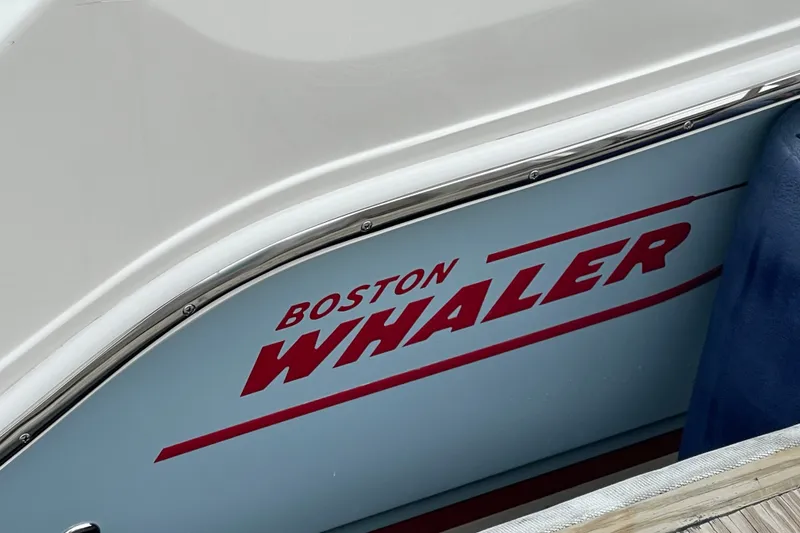 Slide: The Image of 2023 Boston Whaler 240 Vantage boat with logo detail on the side. - 16