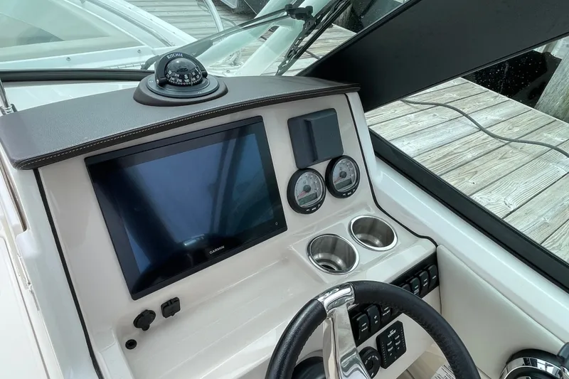 Slide: The Image of Dashboard of 2023 Boston Whaler 240 Vantage with Garmin display and compass. - 53