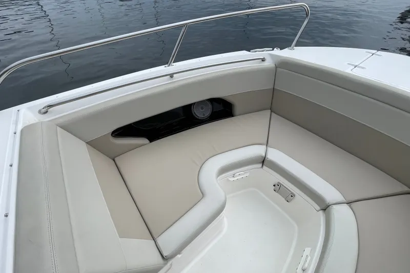 Slide: The Image of 2023 Boston Whaler 240 Vantage boat interior with cushioned seating and railing. - 63