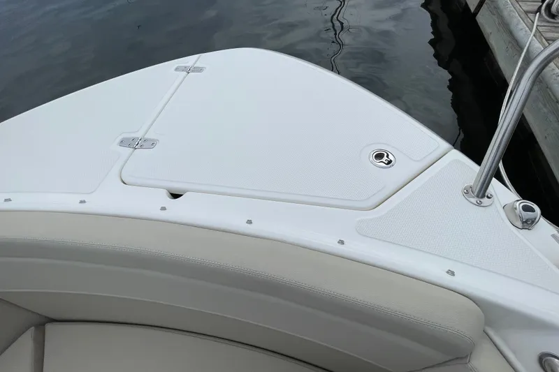 Slide: The Image of 2023 Boston Whaler 240 Vantage boat deck, featuring sleek white design and stainless steel fittings. - 66