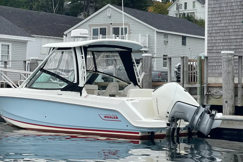 Slide: The Image of 2023 Boston Whaler 240 Vantage boat docked at a marina. - 31