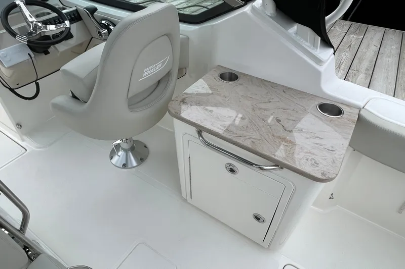 Slide: The Image of 2023 Boston Whaler 240 Vantage interior with helm seat and countertop. - 41