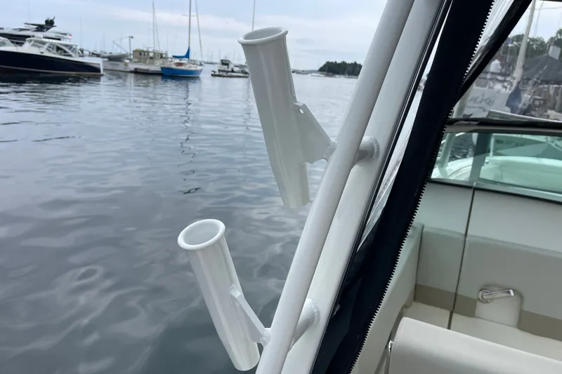 Slide: The Image of Boston Whaler 240 Vantage 2023 boat with rod holders, docked in a marina. - 73