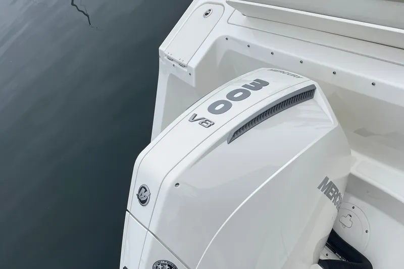 Slide: The Image of 2023 Boston Whaler 240 Vantage with Mercury 400 V8 outboard engine on calm water. - 15