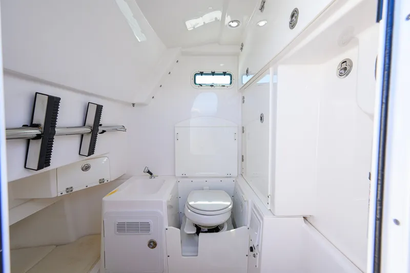 Slide: The Image of Interior of 2018 Everglades 355 Center Console boat with compact bathroom amenities. - 53