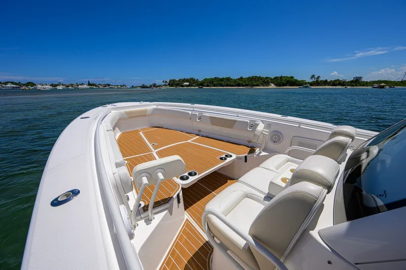 Slide: The Image of 2018 Everglades 355 Center Console boat on water, featuring spacious seating and sleek design. - 21