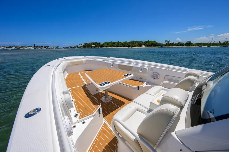 Slide: The Image of 2018 Everglades 355 Center Console boat with luxurious seating on calm waters. - 22
