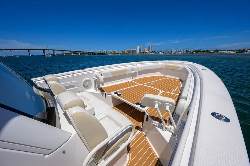 Slide: The Image of 2018 Everglades 355 Center Console boat on water, city skyline in background. - 14