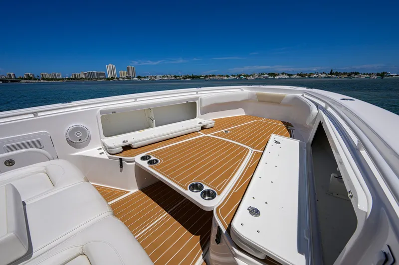 Slide: The Image of 2018 Everglades 355 Center Console boat interior with seating and cup holders, ocean view. - 16