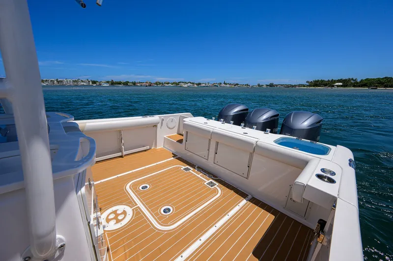 Slide: The Image of 2018 Everglades 355 Center Console boat with triple engines on open water. - 33
