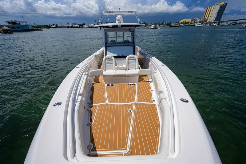 Slide: The Image of 2018 Everglades 355 Center Console boat on water, featuring spacious deck and seating. - 26
