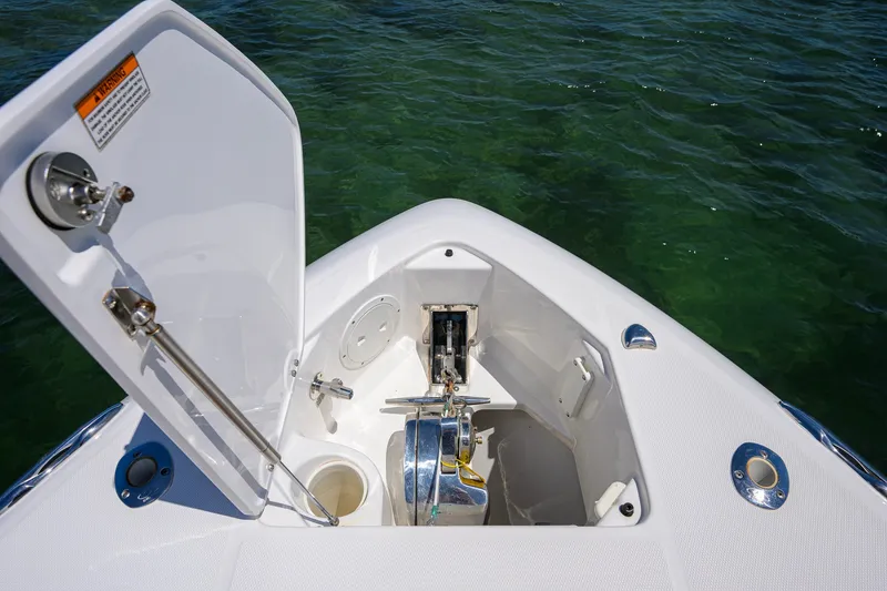 Slide: The Image of Open anchor compartment on 2018 Everglades 355 Center Console boat, floating on clear water. - 25