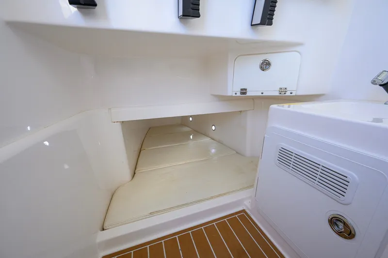 Slide: The Image of Interior cabin of 2018 Everglades 355 Center Console boat, featuring storage and seating area. - 56