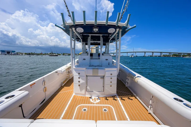 Slide: The Image of 2018 Everglades 355 Center Console boat on water, clear sky, bridge in background. - 37