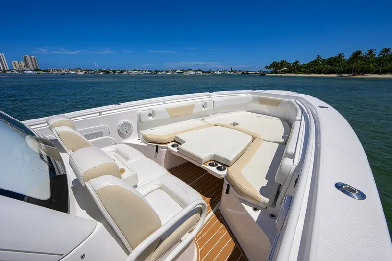 Slide: The Image of 2018 Everglades 355 Center Console boat with luxurious seating on calm waters. - 17