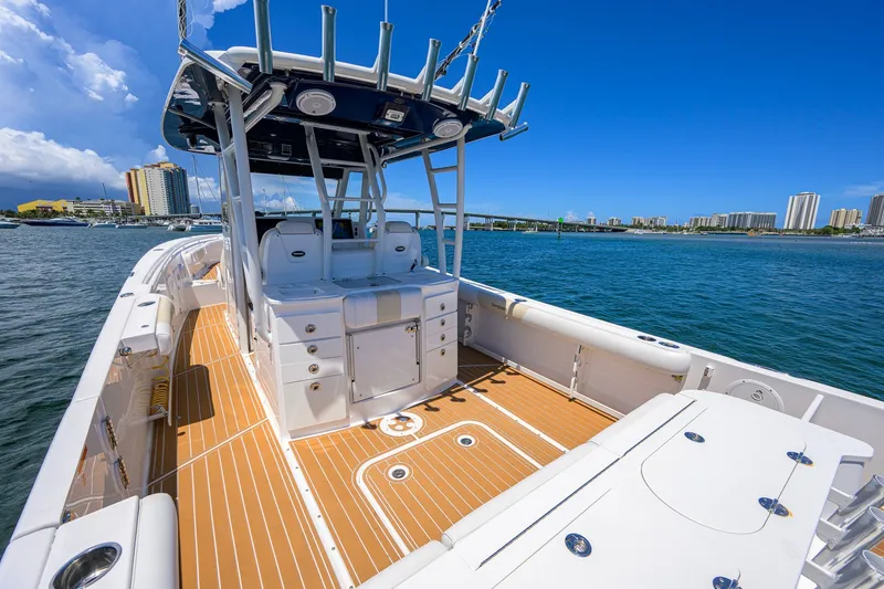 Slide: The Image of 2018 Everglades 355 Center Console boat on water, city skyline in background. - 38