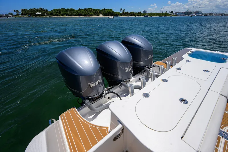 Slide: The Image of 2018 Everglades 355 Center Console with triple Yamaha 300 engines on open water. - 57