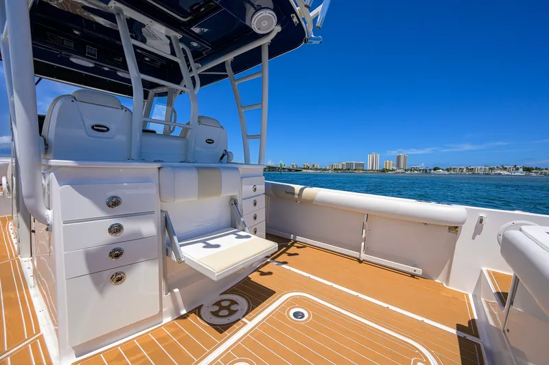 Slide: The Image of 2018 Everglades 355 Center Console boat with seating, ocean view, and city skyline. - 40