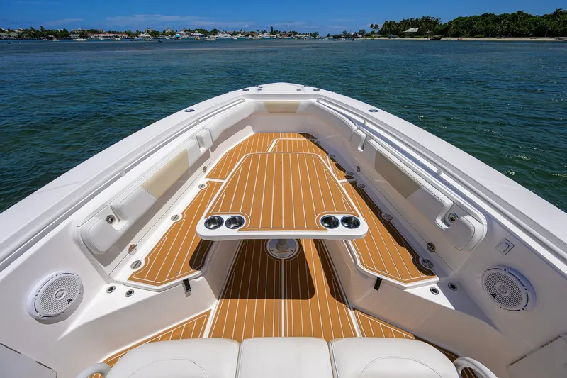 Slide: The Image of 2018 Everglades 355 Center Console boat interior with teak deck and cup holders. - 19