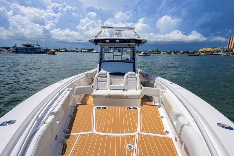Slide: The Image of 2018 Everglades 355 Center Console boat on water, featuring spacious deck and seating. - 27