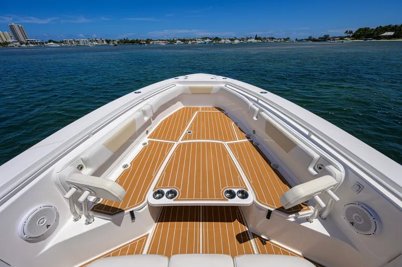 Slide: The Image of 2018 Everglades 355 Center Console boat with teak deck, on calm water. - 18