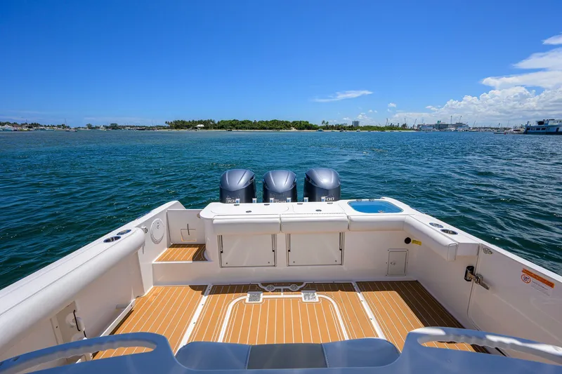 Slide: The Image of 2018 Everglades 355 Center Console boat with triple engines on open water. - 31