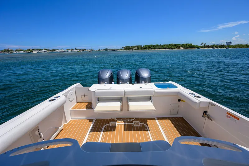 Slide: The Image of 2018 Everglades 355 Center Console boat with triple engines on open water. - 32