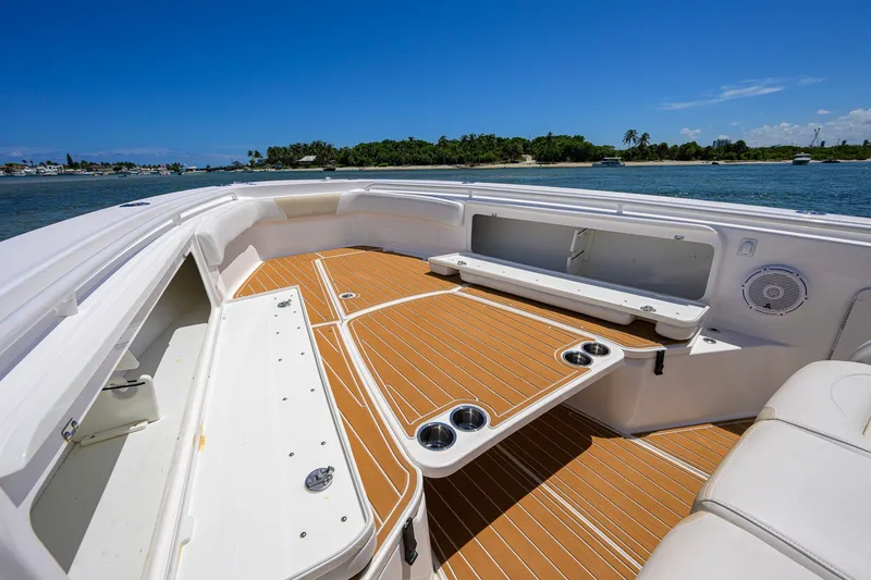 Slide: The Image of 2018 Everglades 355 Center Console boat interior with teak flooring and seating. - 23